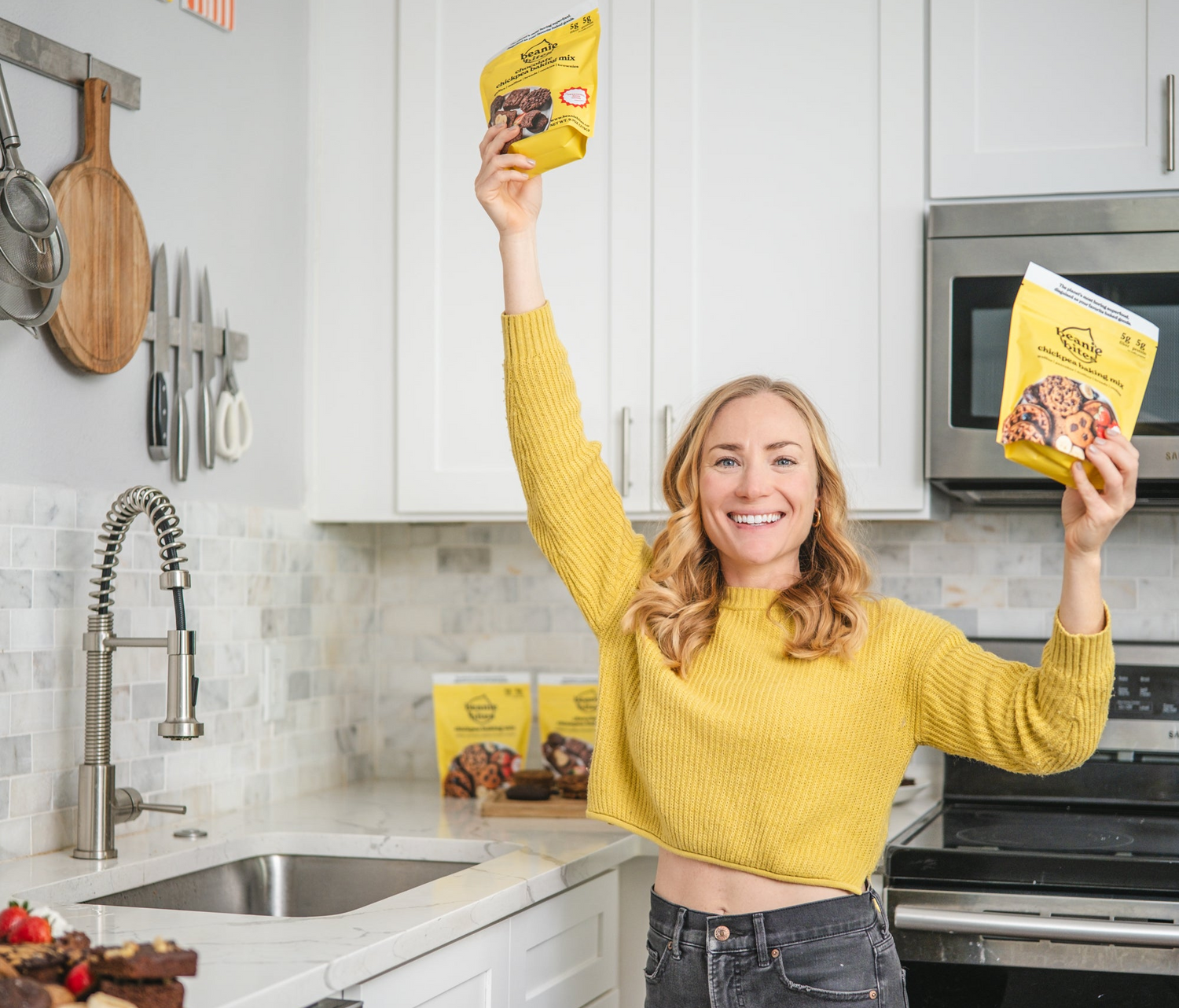 woman in kitchen holding baking mix